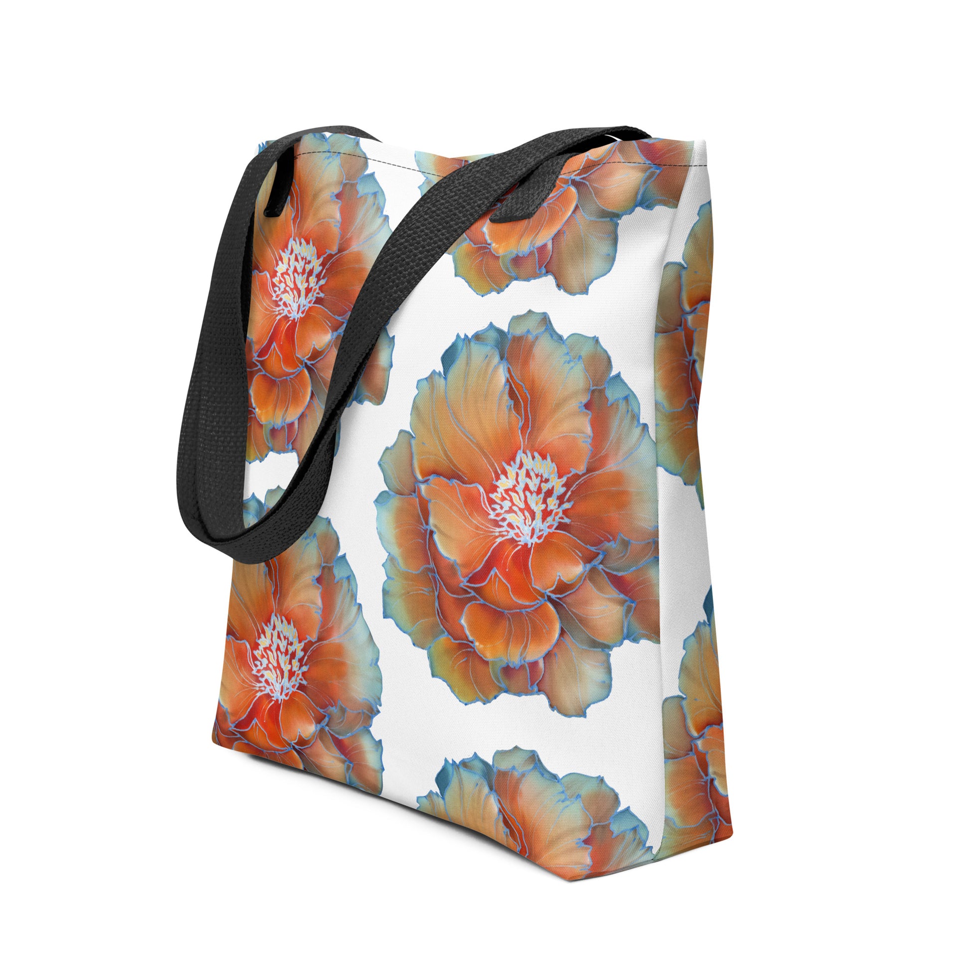 Stijlvolle 15x15 inch draagtas met all-over print van grote bloemen in oranje, goud en wit, afgewerkt met blauwe bloemblad randjes en een zwarte handvatten. zij uitzicht handvat zwart